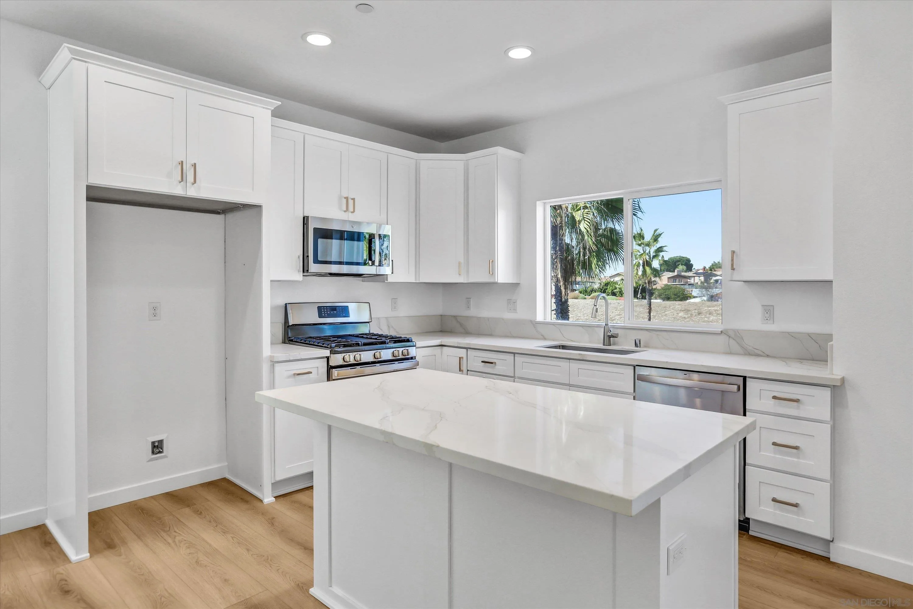 8540 Vista Azul Lemon Grove, CA 91945 - Photo 5 of 33 a kitchen with white cabinets and a sink