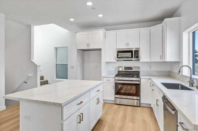 a kitchen with a sink stove and refrigerator