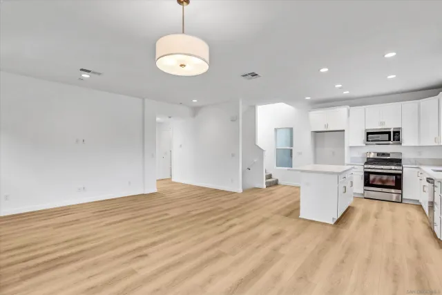 a view of kitchen with sink microwave and refrigerator