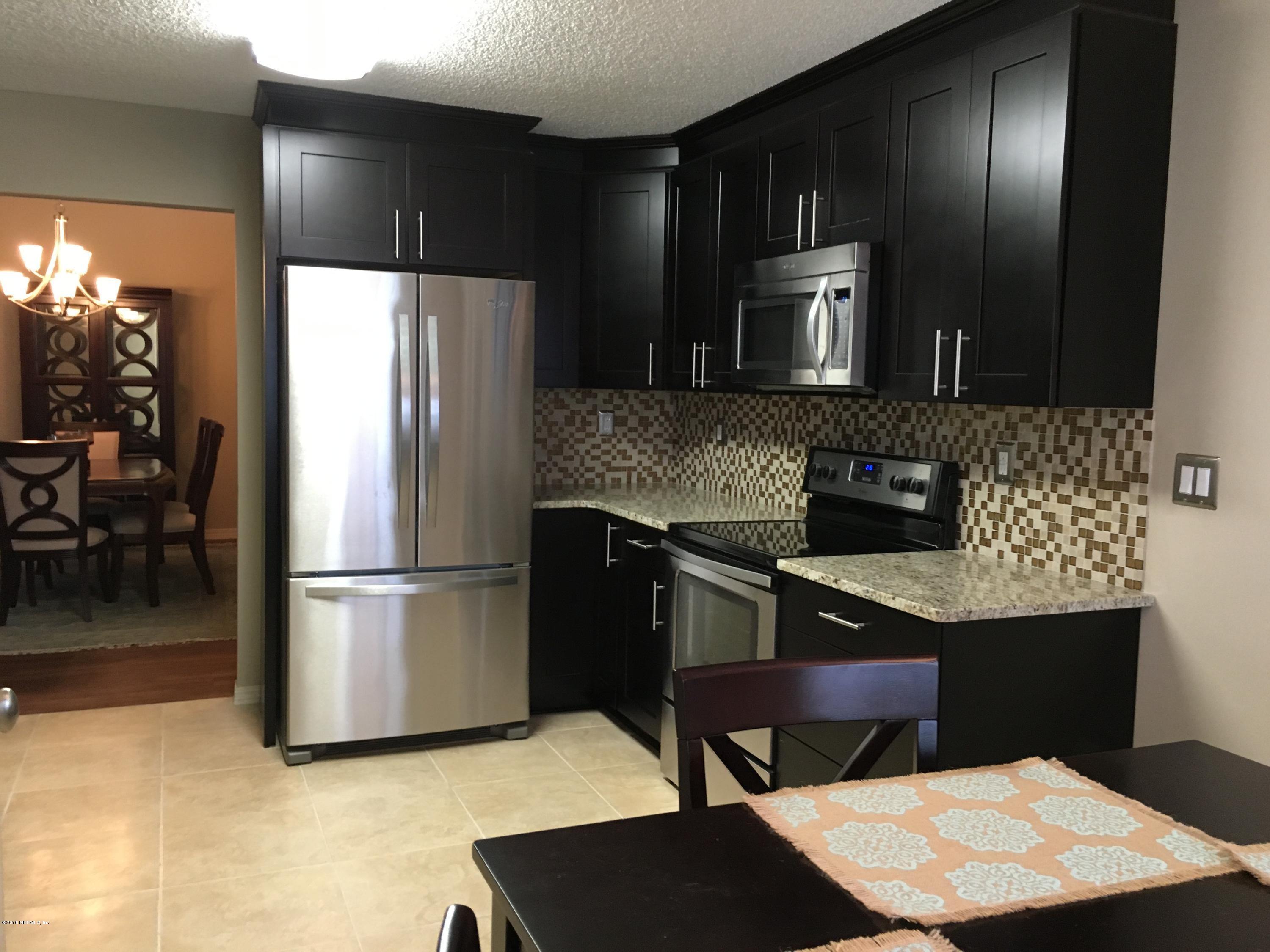 12788 Attrill Road Jacksonville, FL 32258 - Photo 1 of 20 a kitchen with a refrigerator and a sink