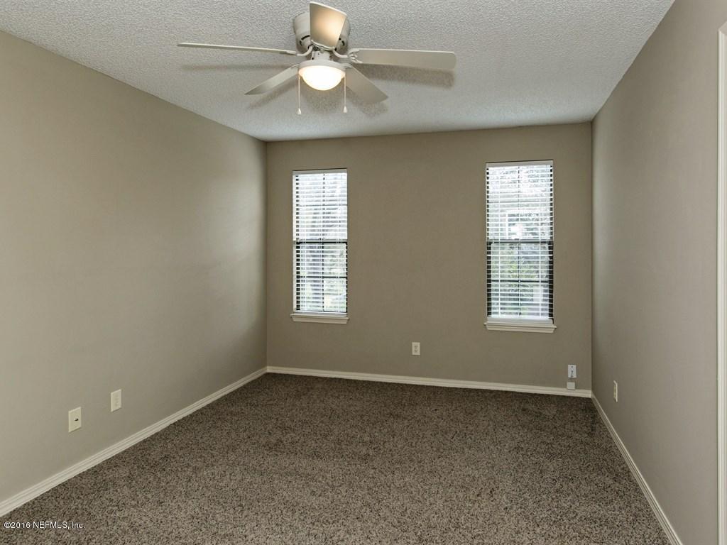 12788 Attrill Road Jacksonville, FL 32258 - Photo 12 of 20 an empty room with windows and fan