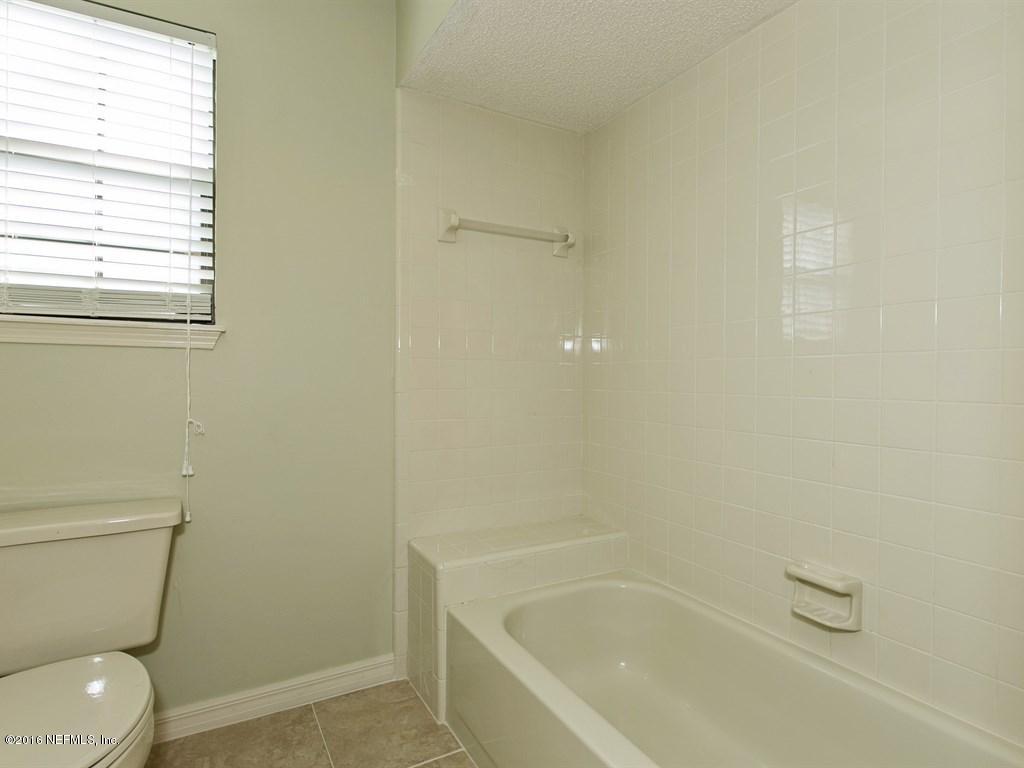 12788 Attrill Road Jacksonville, FL 32258 - Photo 14 of 20 a white toilet sitting next to a bath tub