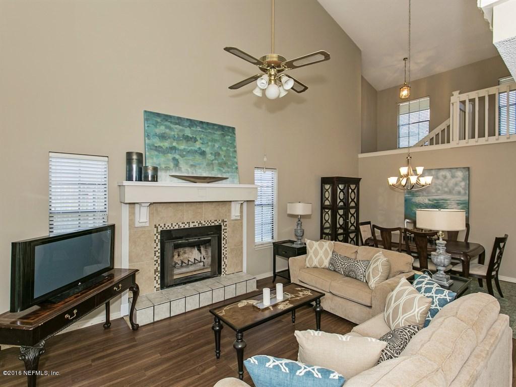 12788 Attrill Road Jacksonville, FL 32258 - Photo 5 of 20 a living room with furniture a fireplace and a flat screen tv