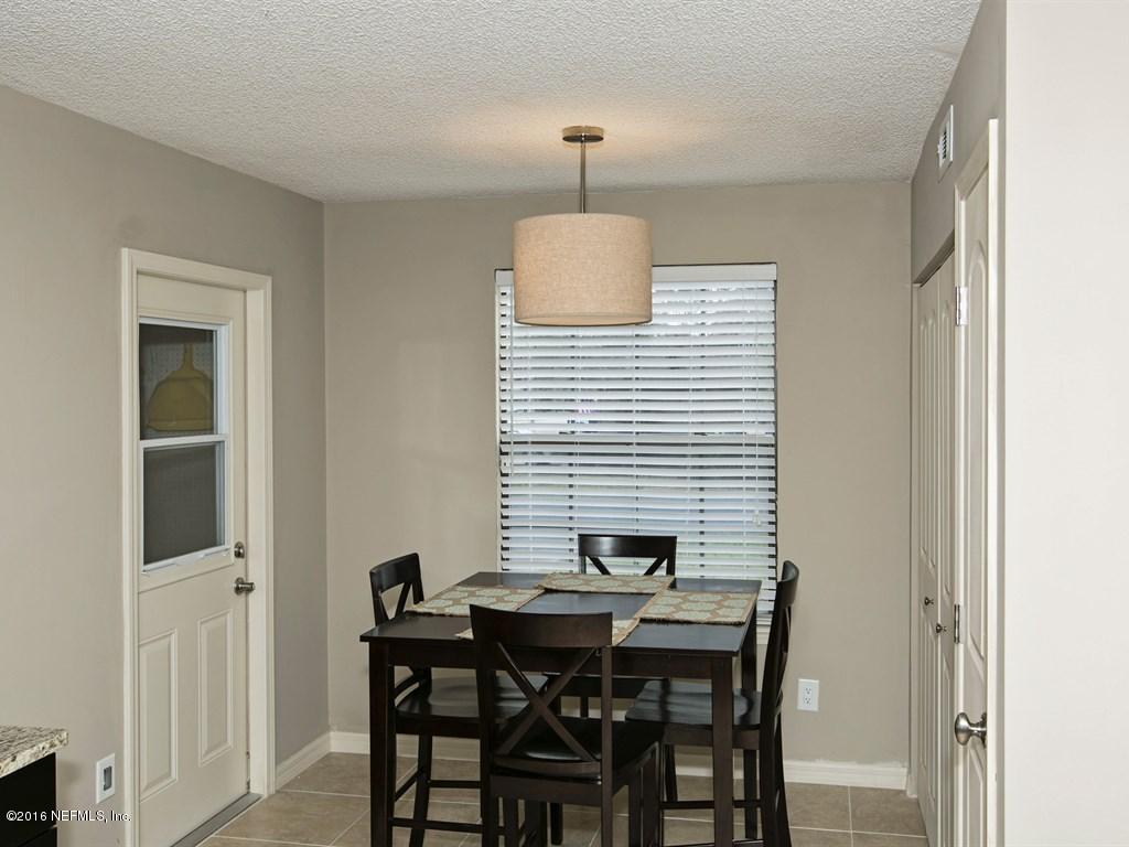 12788 Attrill Road Jacksonville, FL 32258 - Photo 7 of 20 a view of a dining room with furniture and wooden floor
