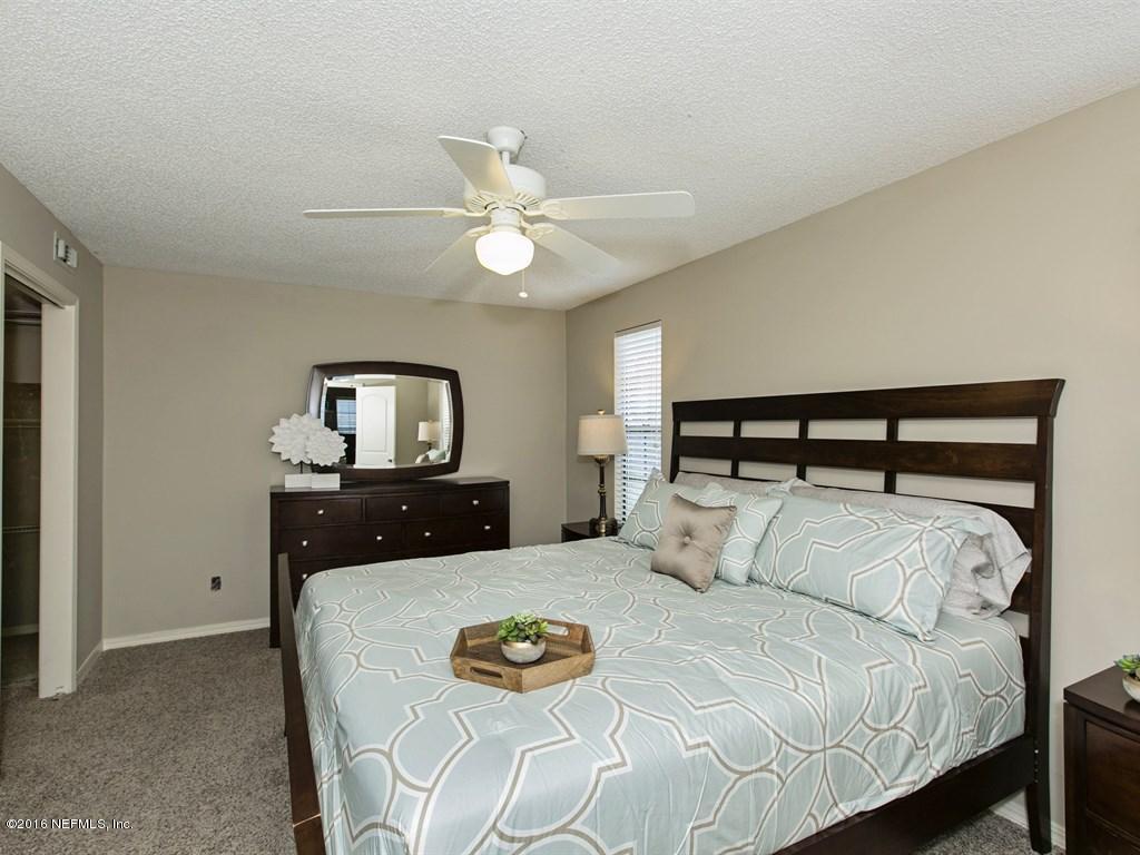 12788 Attrill Road Jacksonville, FL 32258 - Photo 8 of 20 a bedroom with a bed and a chandelier