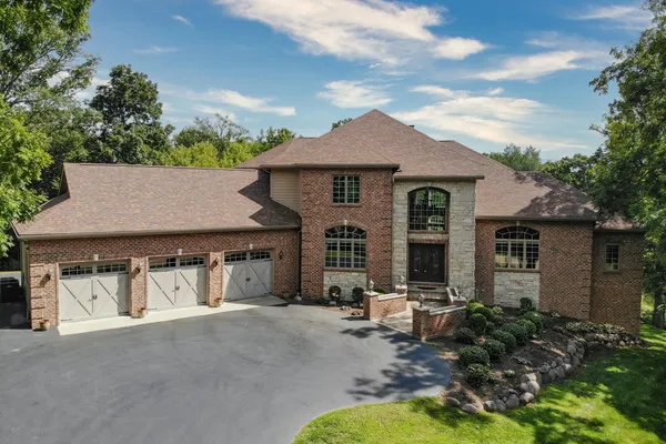 a view of a house with a yard and potted plants
