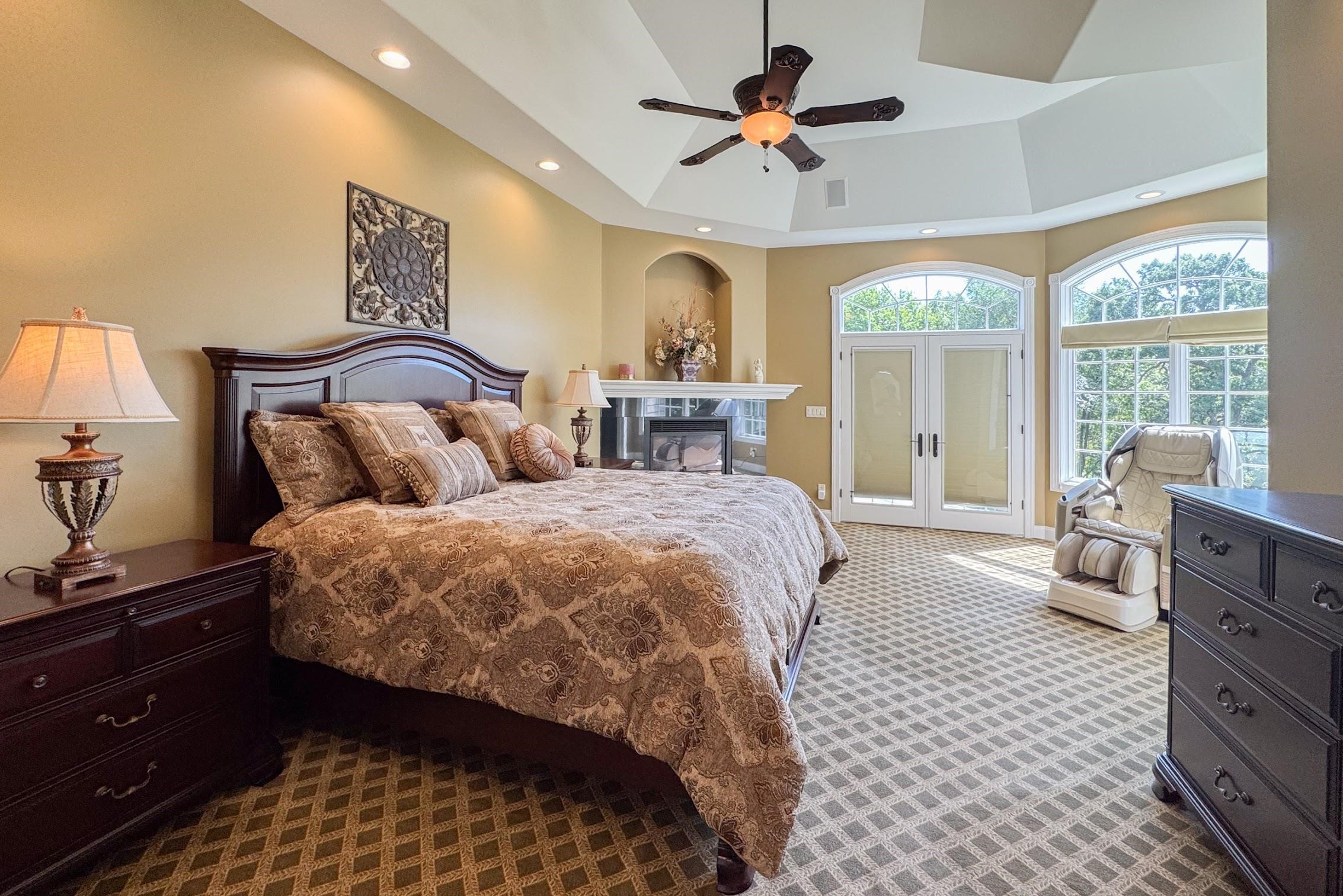 163 Russell Road Oregon, IL 61061 - Photo 27 of 64 a spacious bedroom with a bed and a chandelier