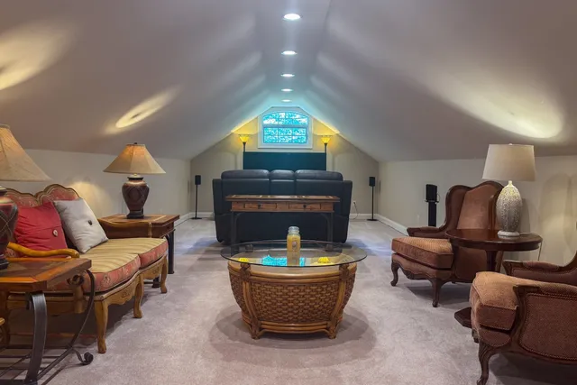 a living room with furniture a fireplace and a floor to ceiling window