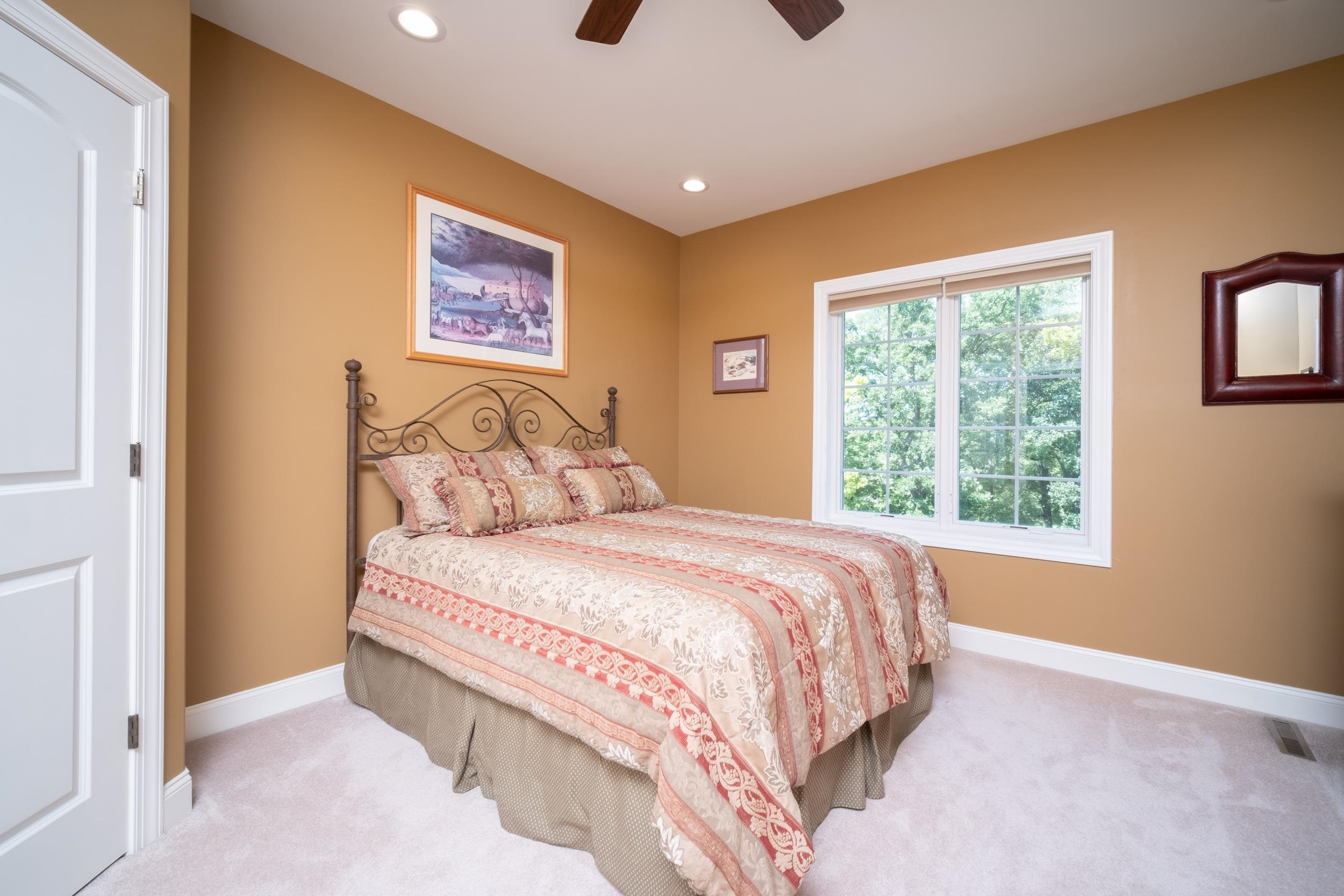 163 Russell Road Oregon, IL 61061 - Photo 41 of 64 a bedroom with a bed and a painting on the wall