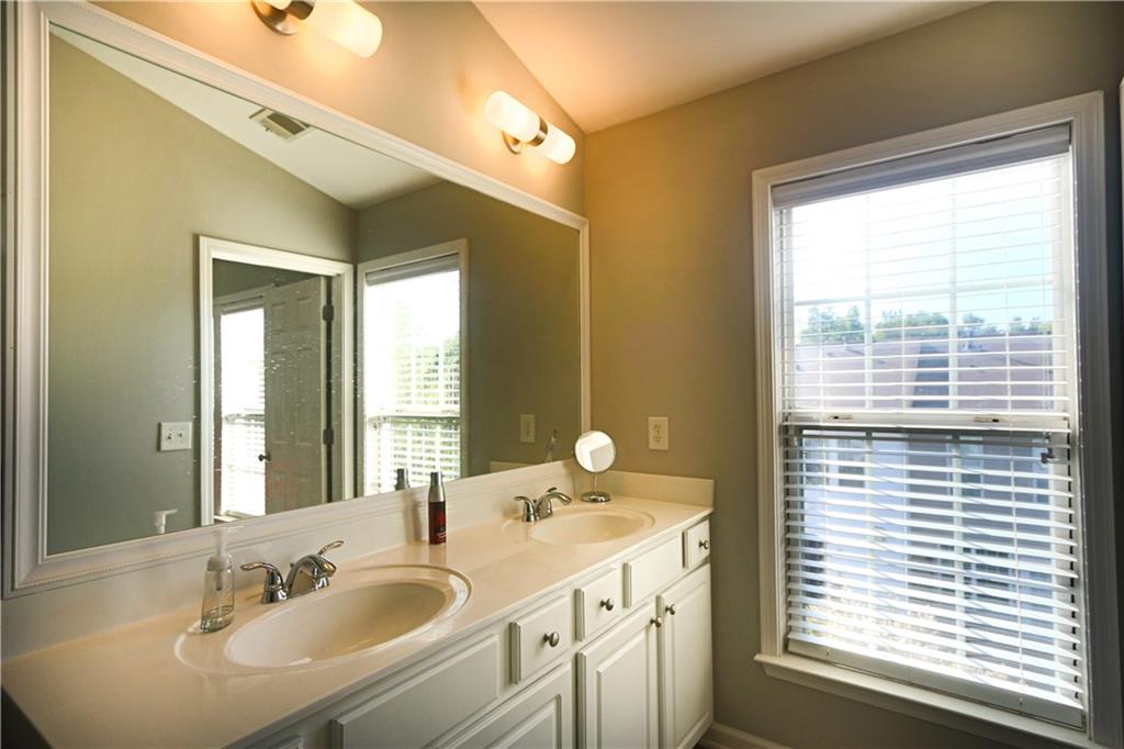 1035 Thornborough Drive Alpharetta, GA 30004 - Photo 7 of 14 a bathroom with a sink double vanity and a mirror