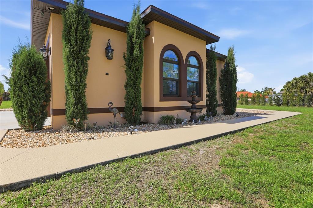 13429 Montevista Road Clermont, FL 34711 - Photo 6 of 89 a front view of a house with garden
