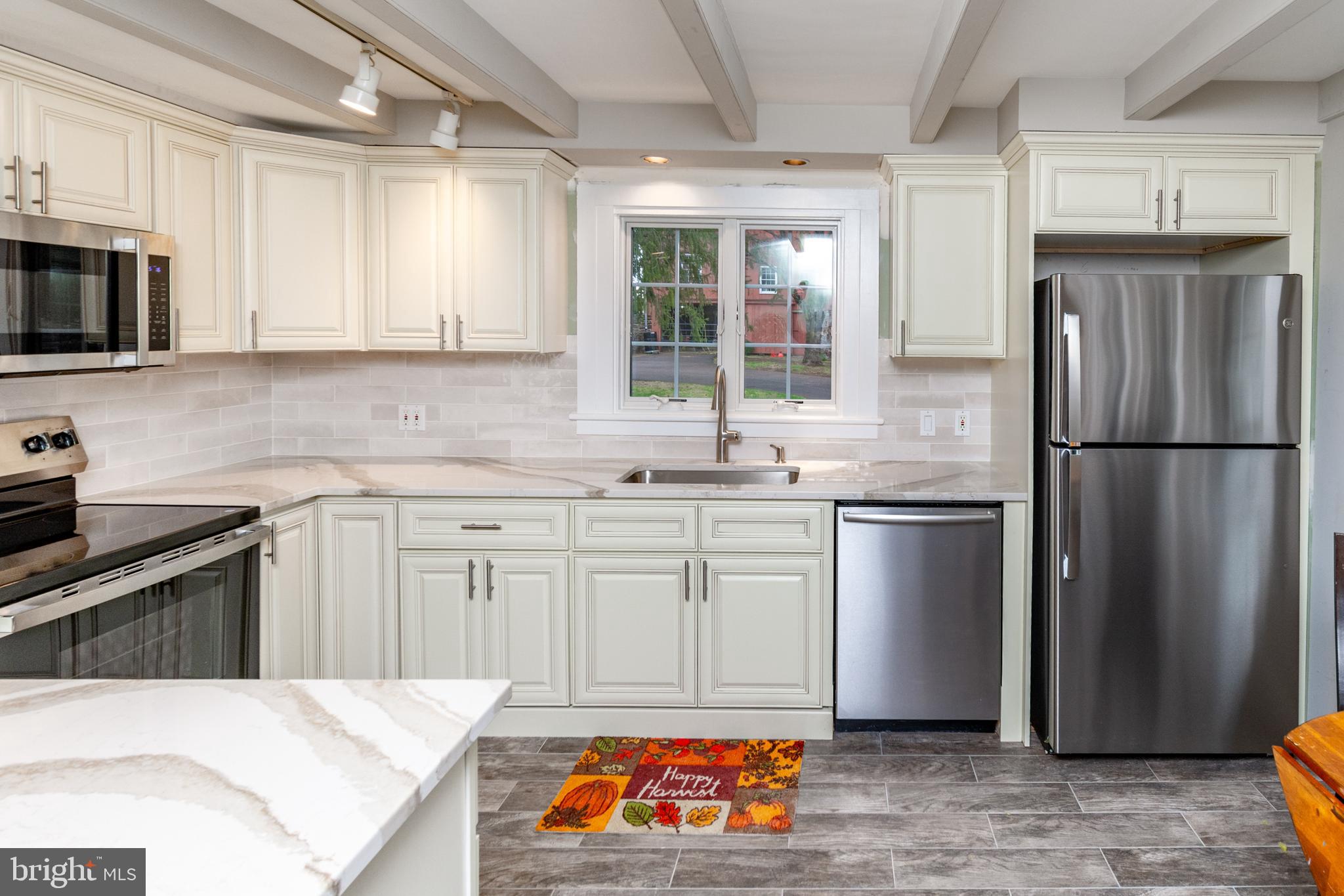 180 Municipal Road Pipersville, PA 18947 - Photo 23 of 60 a kitchen with white cabinets a refrigerator and a sink