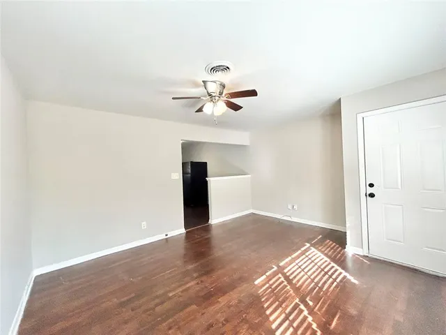 an empty room with fan and a ceiling fan