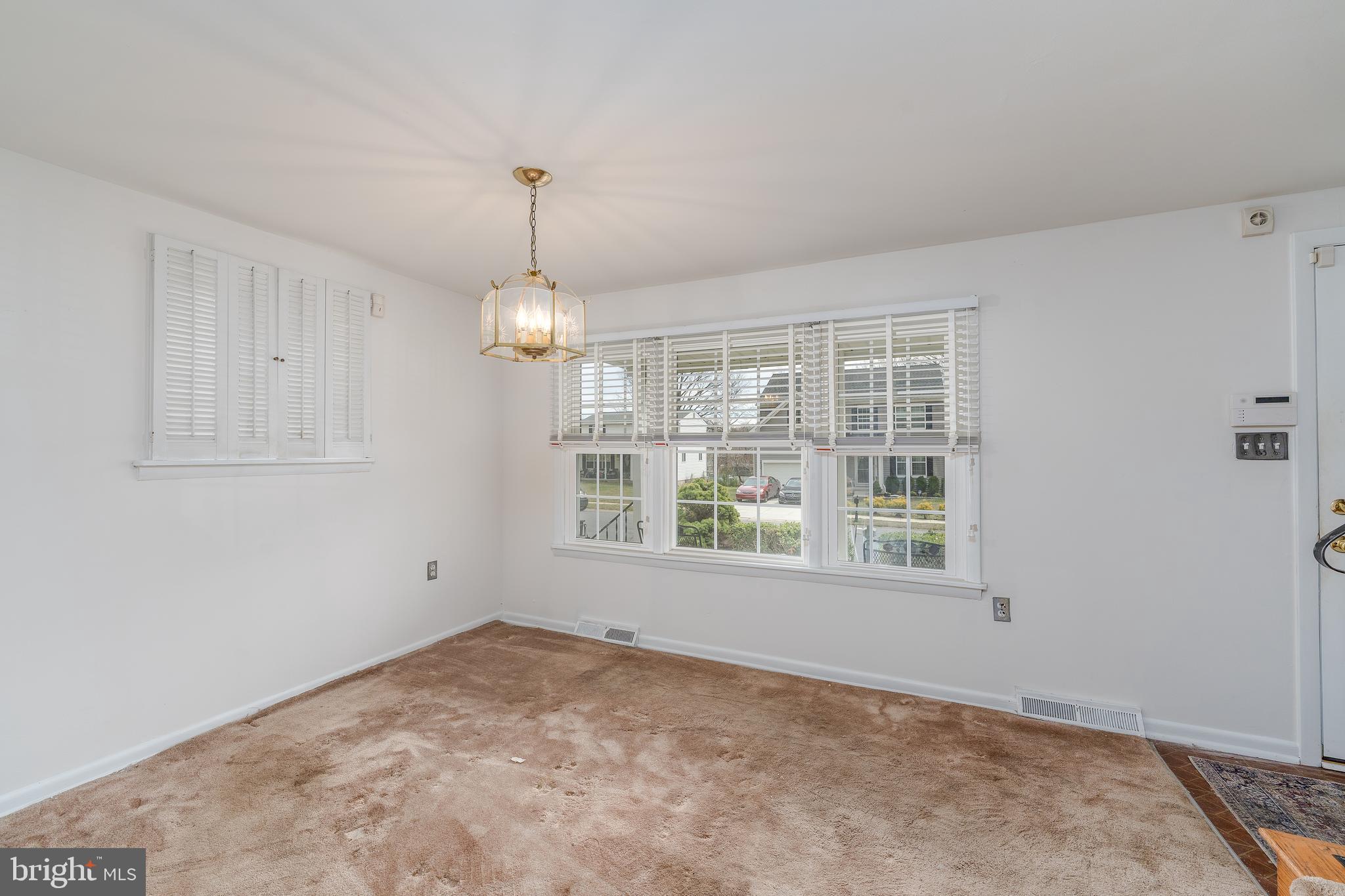 1412 Willshire Drive Aberdeen, MD 21001 - Photo 5 of 28 an empty room with chandelier fan and windows