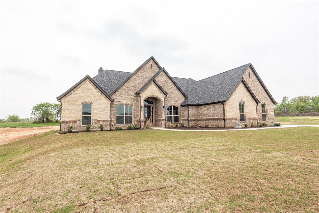 a view of a house with yard and sitting area