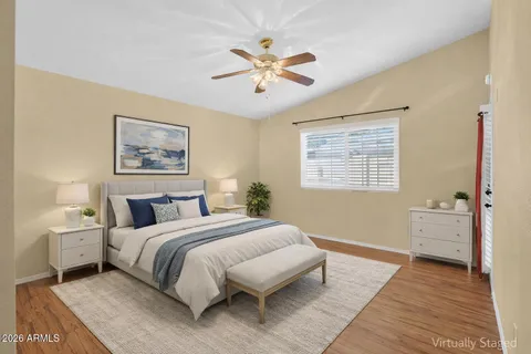 a spacious bedroom with a large bed and a chandelier