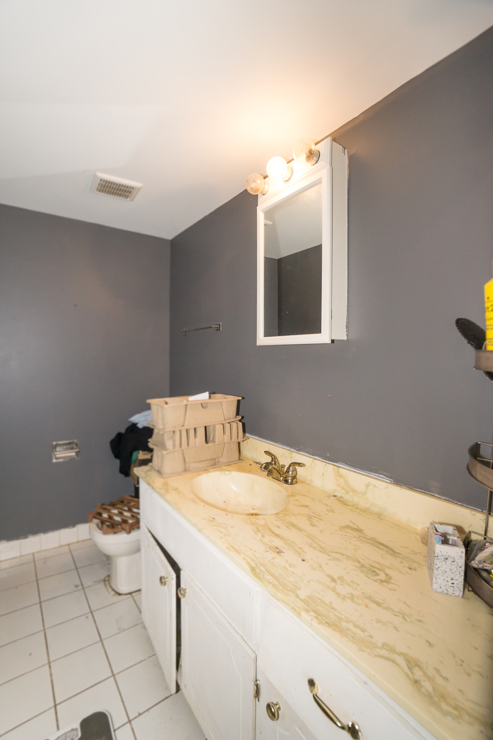 154 East Bailey Road, Unit A Naperville, IL 60565 - Photo 6 of 9 a bathroom with a sink toilet and vanity