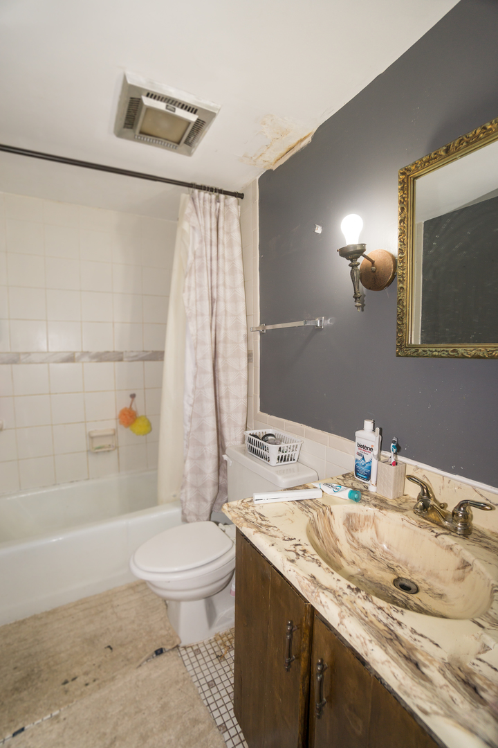 154 East Bailey Road, Unit A Naperville, IL 60565 - Photo 7 of 9 a bathroom with a granite countertop sink toilet and shower
