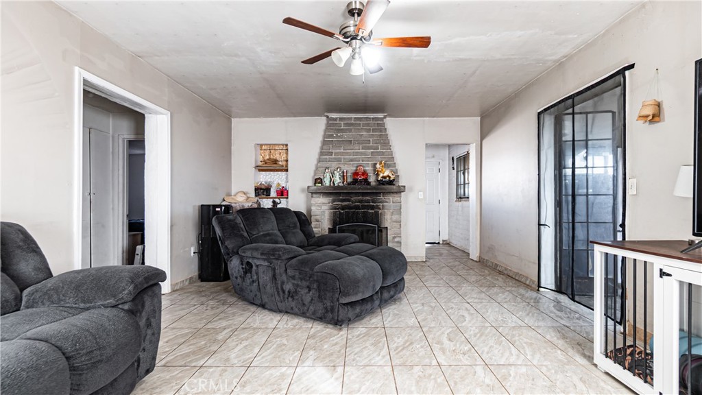 3606 Mojave Road Twentynine Palms, CA 92277 - Photo 14 of 47 a living room with furniture a fireplace and a chandelier