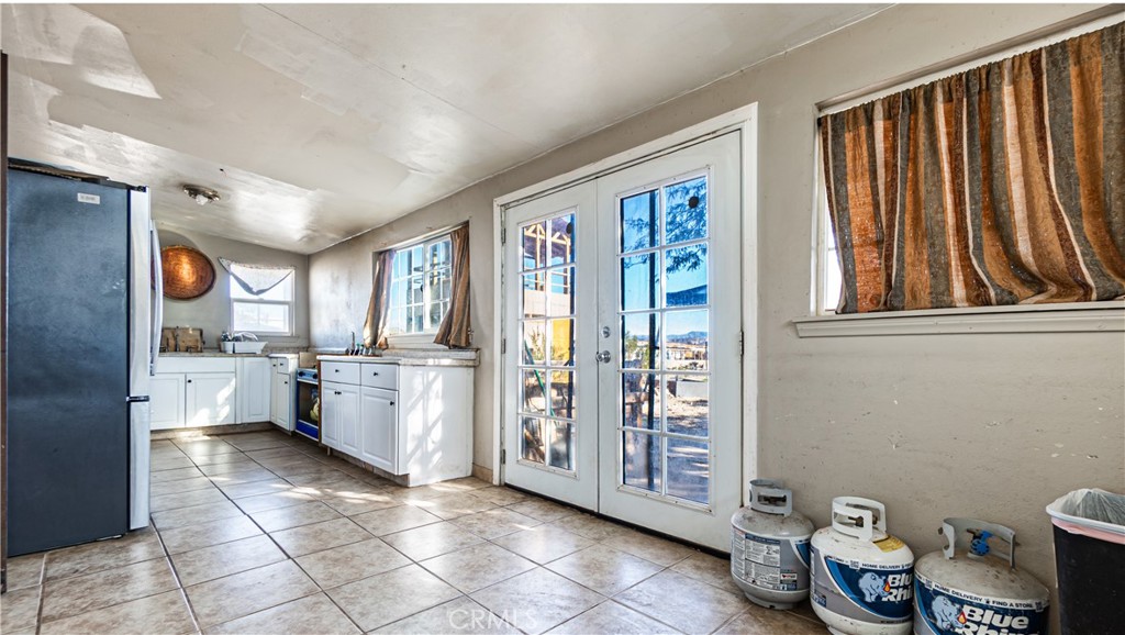 3606 Mojave Road Twentynine Palms, CA 92277 - Photo 16 of 47 a kitchen with a refrigerator and wooden cabinets