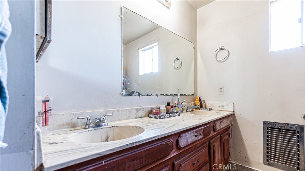 3606 Mojave Road Twentynine Palms, CA 92277 - Photo 22 of 47 a bathroom with a granite countertop sink and a mirror