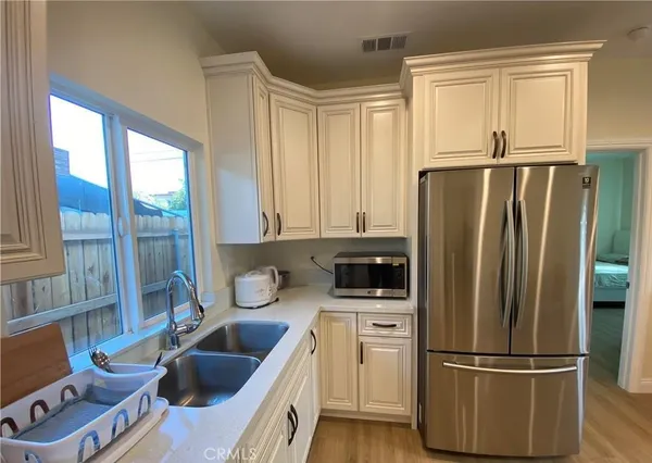 a kitchen with a refrigerator a sink and cabinets