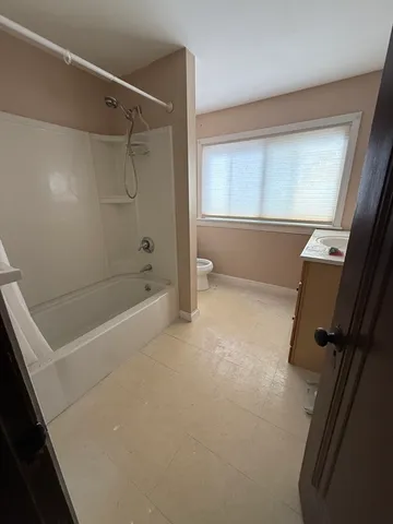 a bathroom with a bathtub and a shower