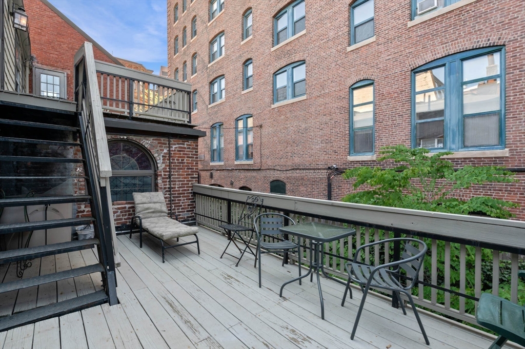 36 Joy Street, Unit F2 Boston, MA 02114 - Photo 12 of 17 a view of balcony with two chairs and wooden floor