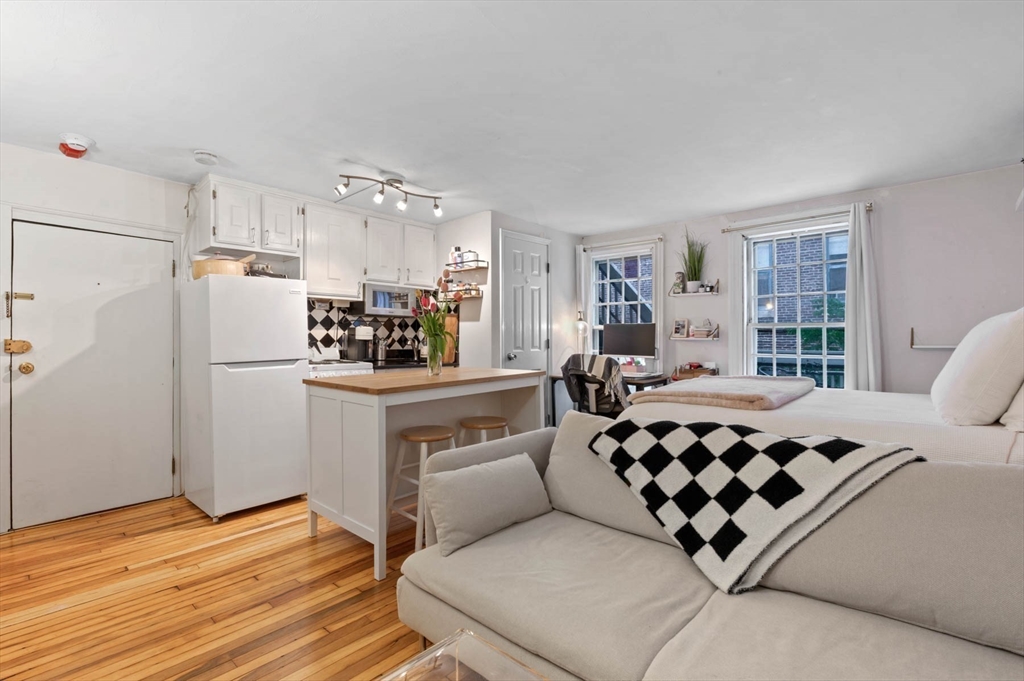 36 Joy Street, Unit F2 Boston, MA 02114 - Photo 2 of 17 a kitchen with stainless steel appliances a refrigerator and a stove top oven