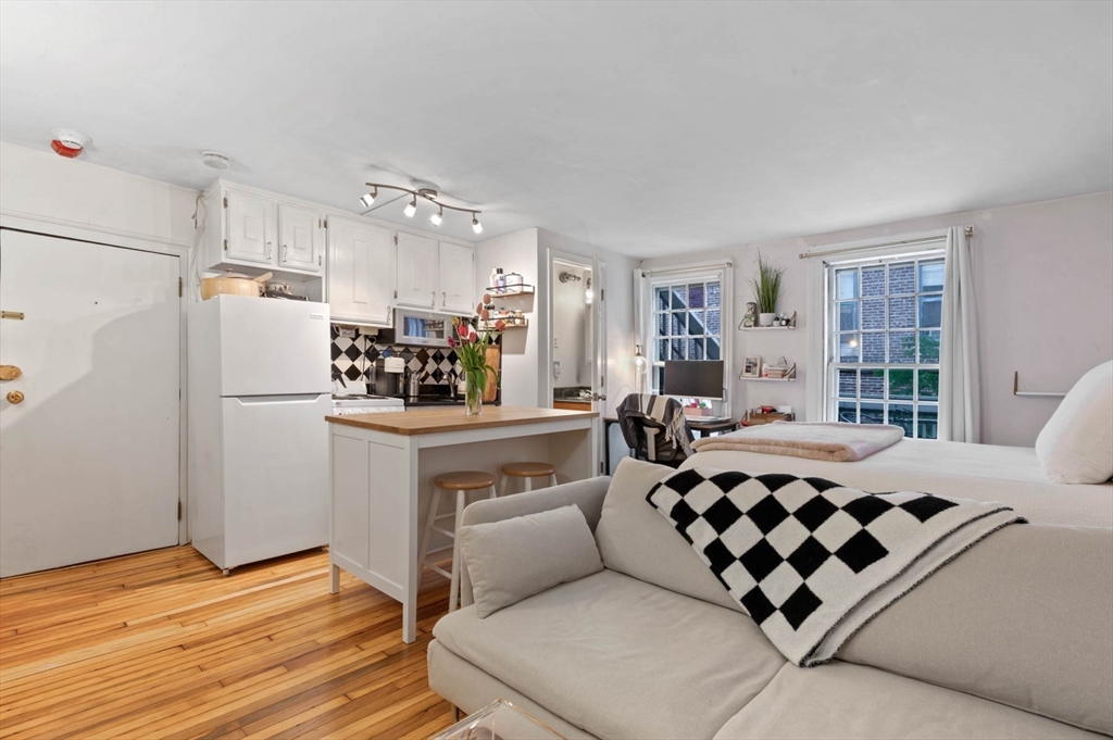 36 Joy Street, Unit F2 Boston, MA 02114 - Photo 3 of 17 a kitchen with stainless steel appliances granite countertop a refrigerator sink and cabinets