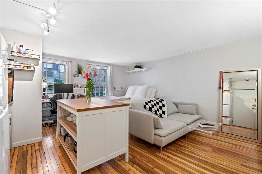 36 Joy Street, Unit F2 Boston, MA 02114 - Photo 4 of 17 a living room with furniture and a table