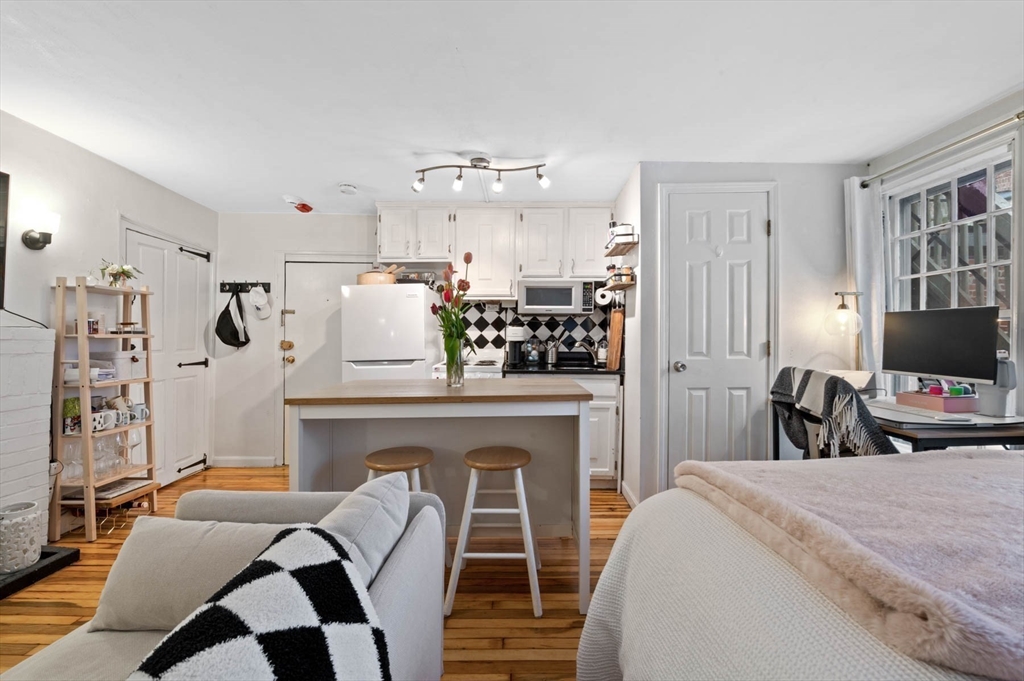 36 Joy Street, Unit F2 Boston, MA 02114 - Photo 5 of 17 a bedroom with furniture and a fireplace