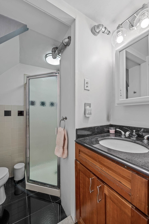 36 Joy Street, Unit F2 Boston, MA 02114 - Photo 10 of 17 a bathroom with a granite countertop sink toilet and shower