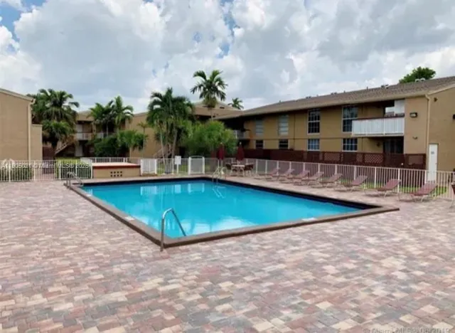 a view of a swimming pool with a patio