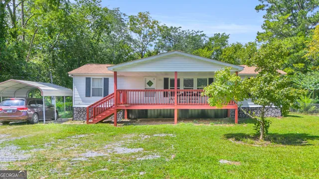 a front view of a house with a yard table and chairs