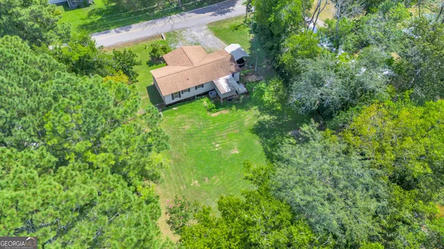 an aerial view of a house with a yard