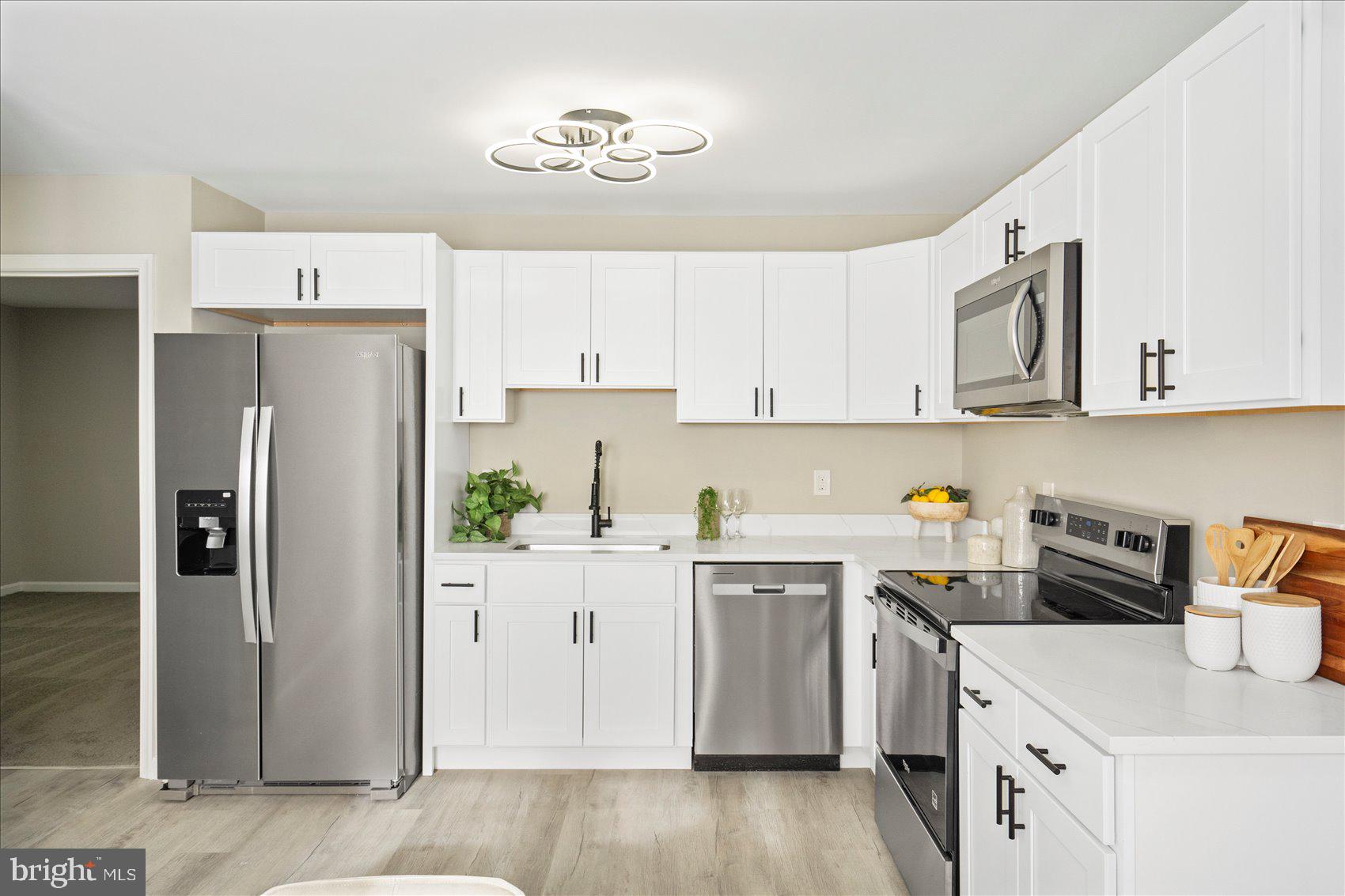 3466 Albantowne Way Edgewood, MD 21040 - Photo 11 of 36 a kitchen with stainless steel appliances a refrigerator sink and cabinets