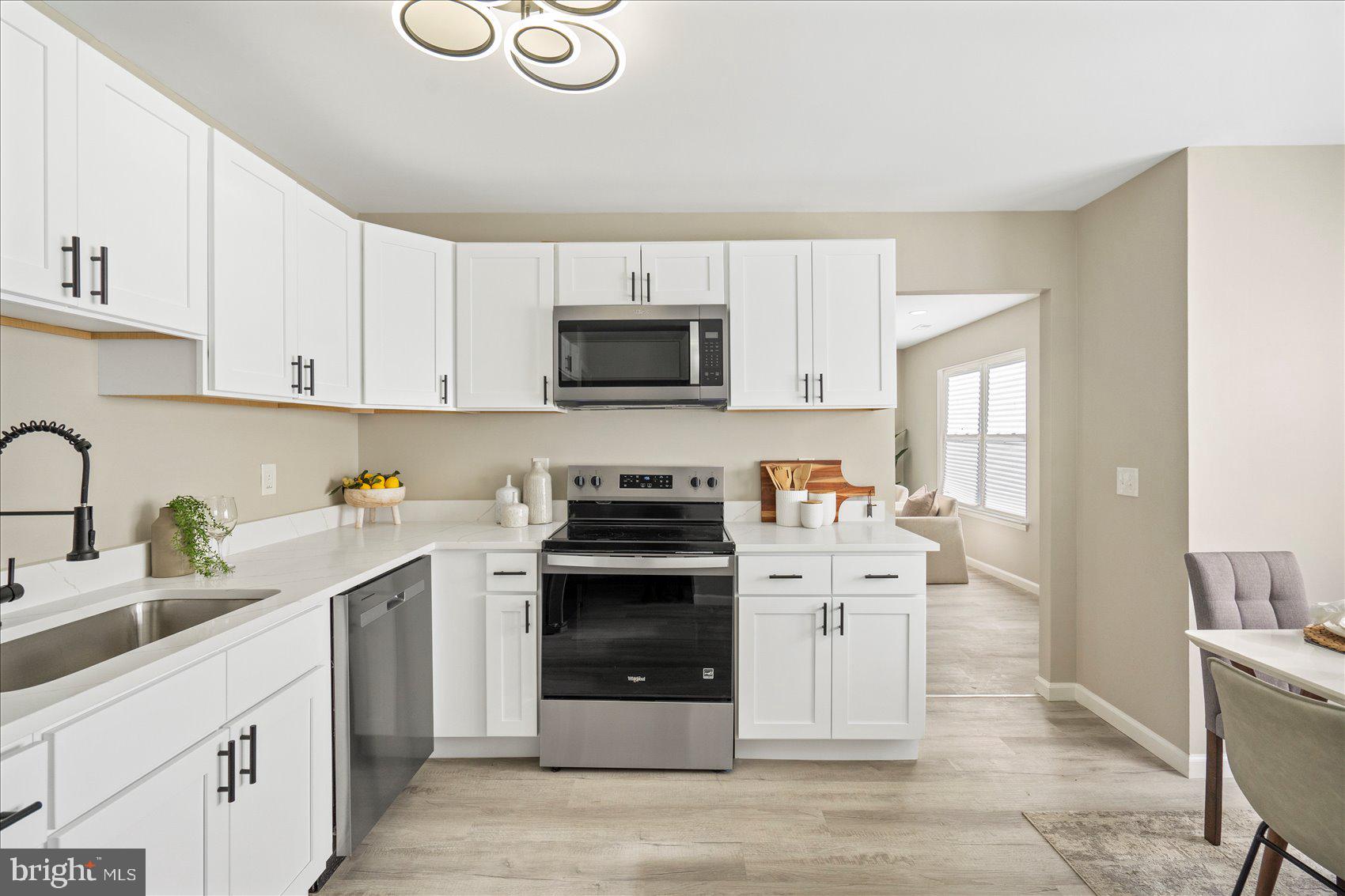 3466 Albantowne Way Edgewood, MD 21040 - Photo 12 of 36 a kitchen with stainless steel appliances a stove sink and cabinets