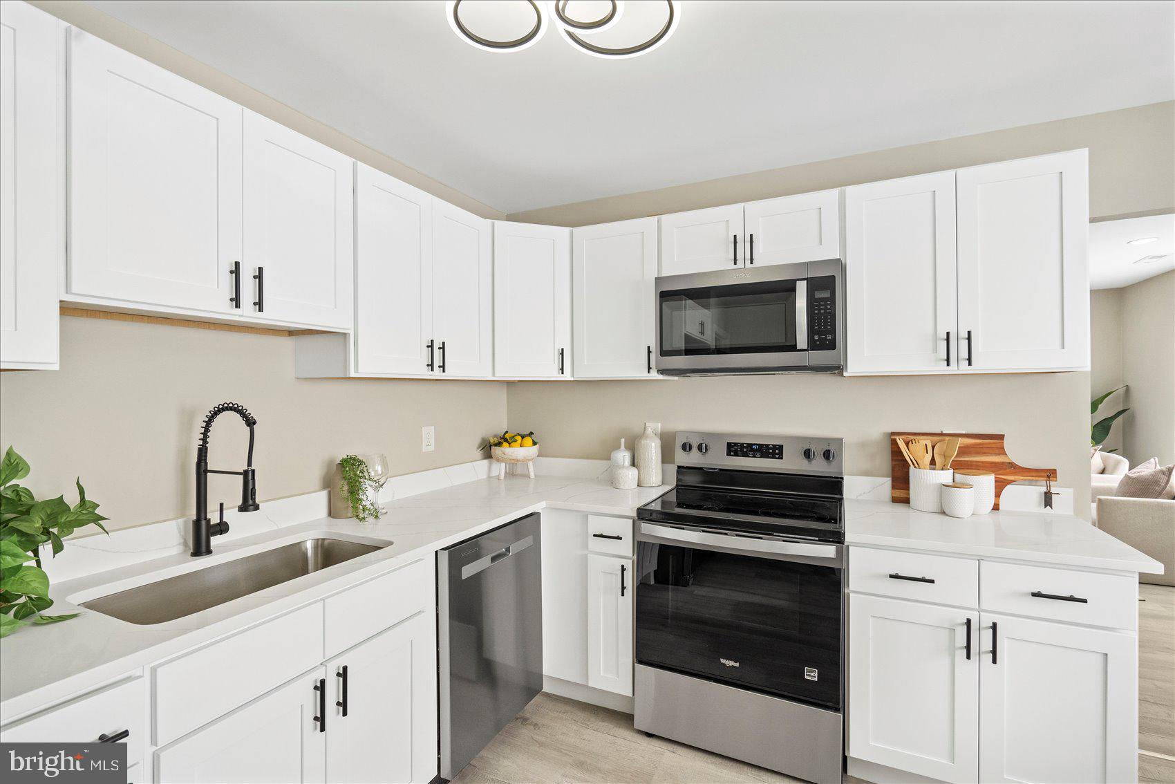 3466 Albantowne Way Edgewood, MD 21040 - Photo 13 of 36 a kitchen with white cabinets and stainless steel appliances
