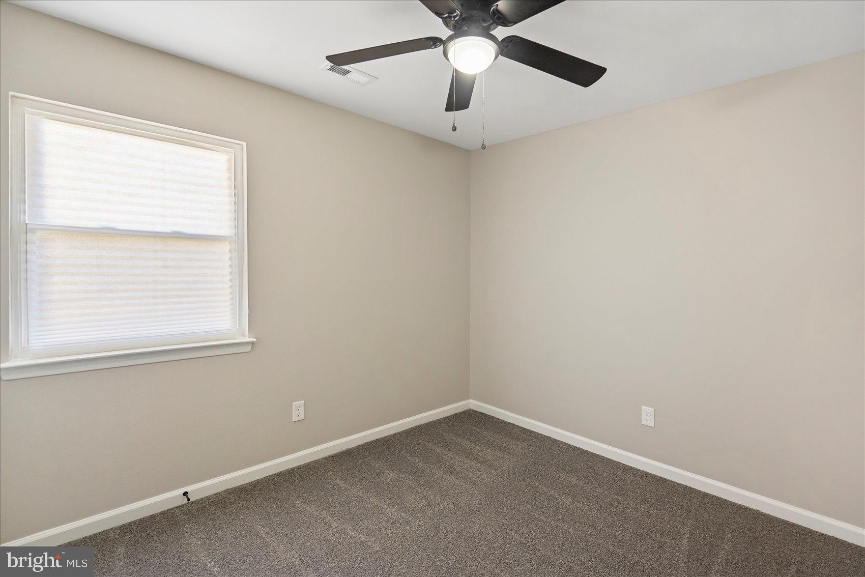 3466 Albantowne Way Edgewood, MD 21040 - Photo 29 of 36 an empty room with a window and a fan