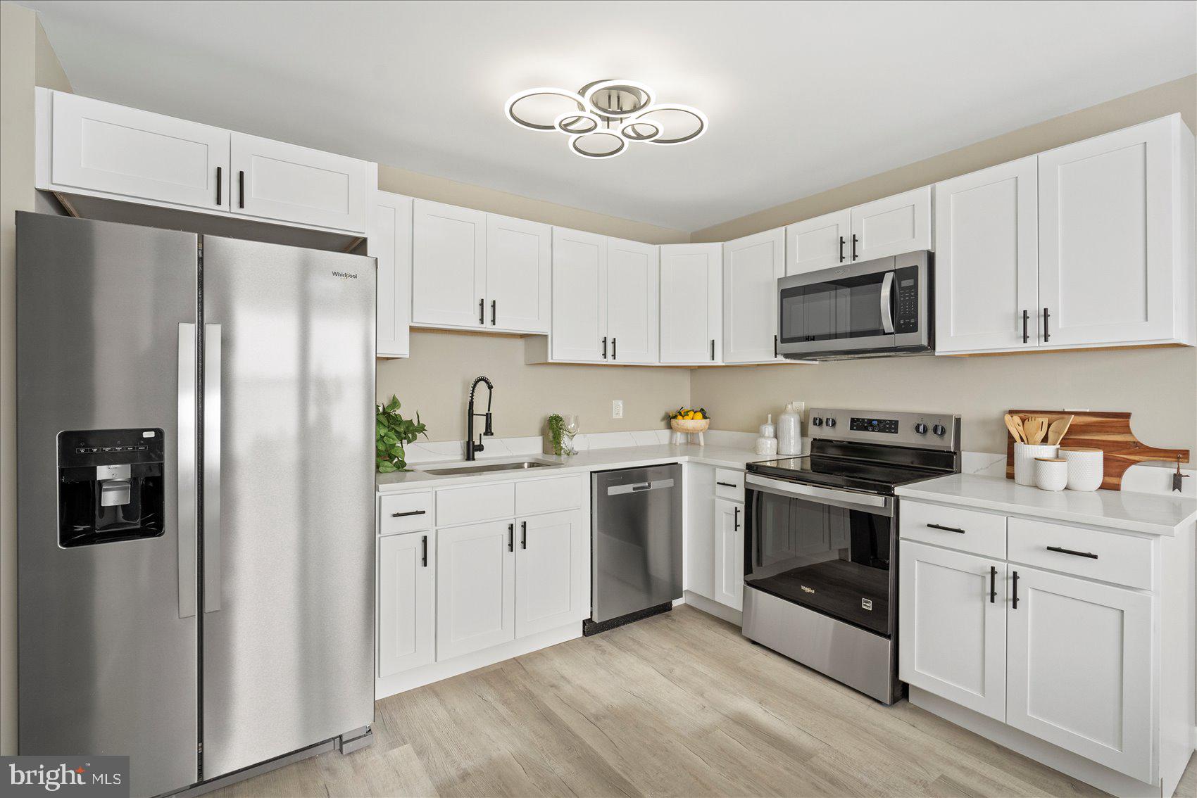3466 Albantowne Way Edgewood, MD 21040 - Photo 10 of 36 a kitchen with cabinets stainless steel appliances and a counter space