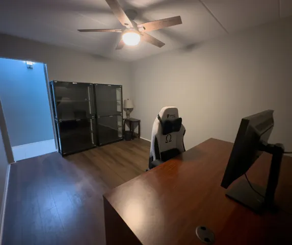 a view of workspace with furniture and wooden floor