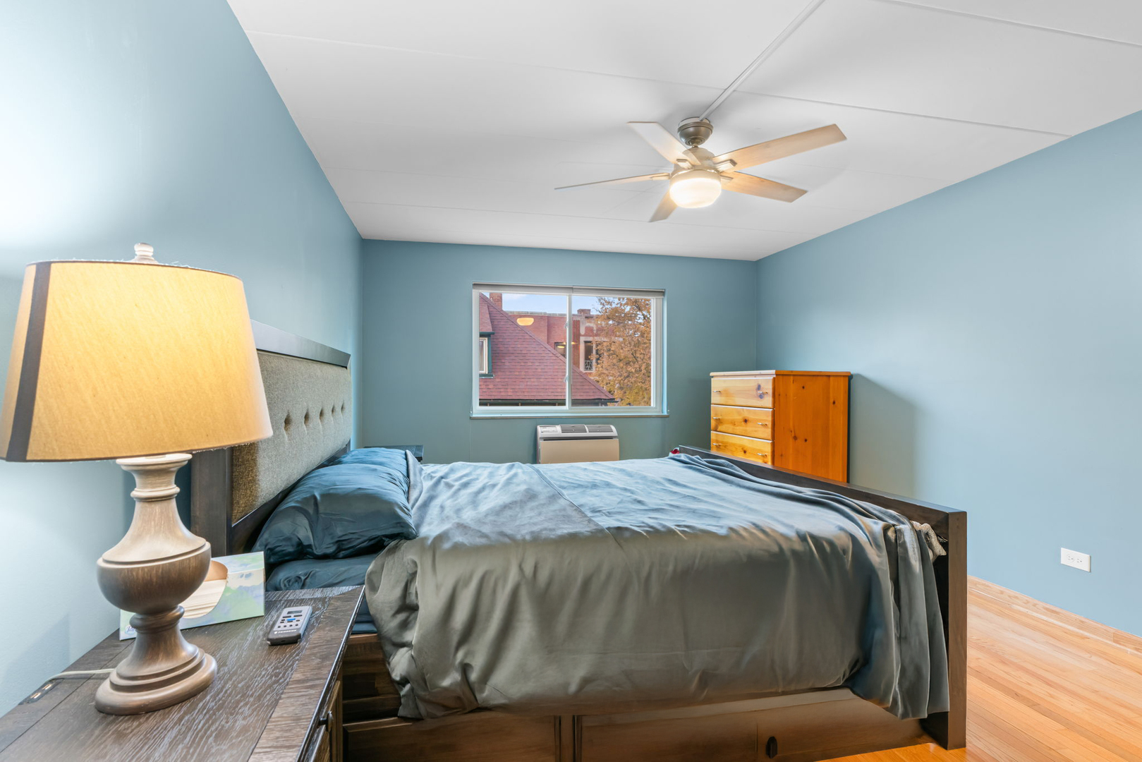 222 North Grove Avenue, Unit 2B Oak Park, IL 60302 - Photo 13 of 20 a bedroom with a bed and a chandelier