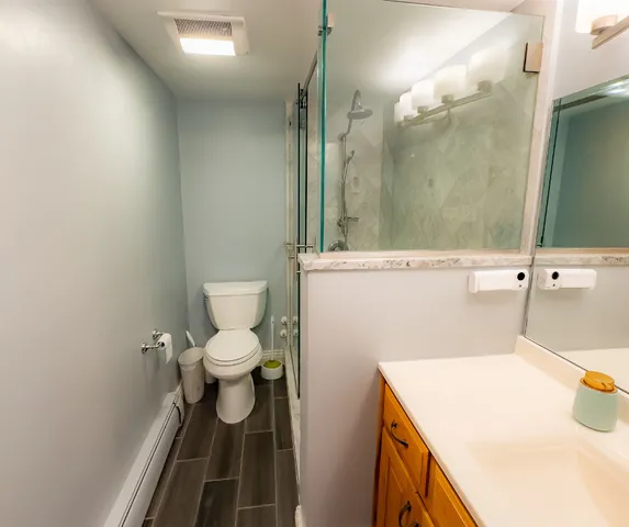 a bathroom with a sink a toilet and a mirror