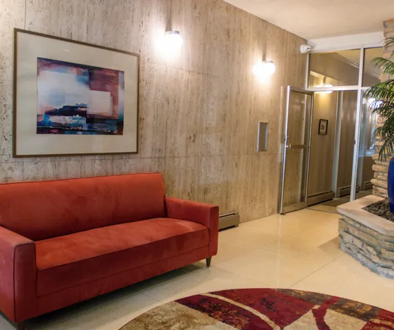 a blue couch sitting in a room next to a bathroom