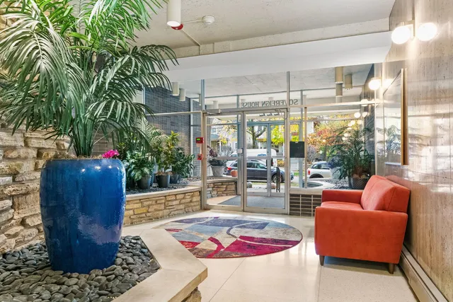 a living room filled with furniture and a potted plant