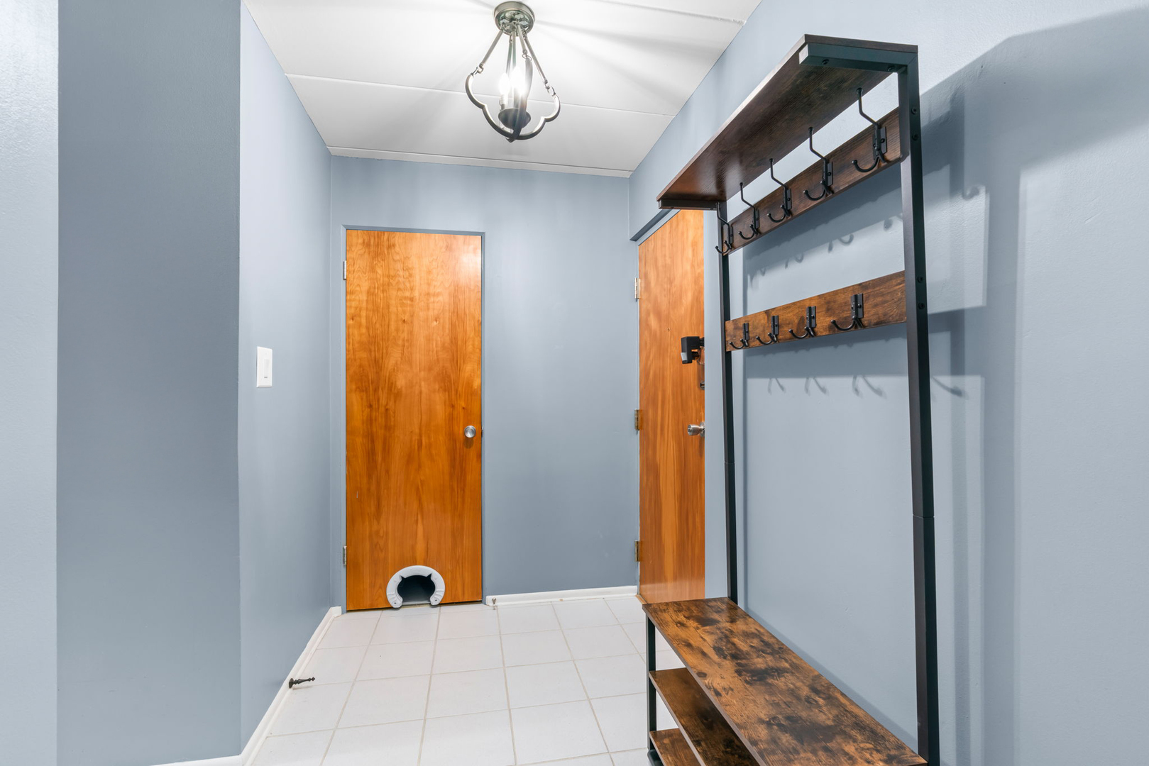 222 North Grove Avenue, Unit 2B Oak Park, IL 60302 - Photo 8 of 20 a view of a hallway with wooden floor and a chandelier