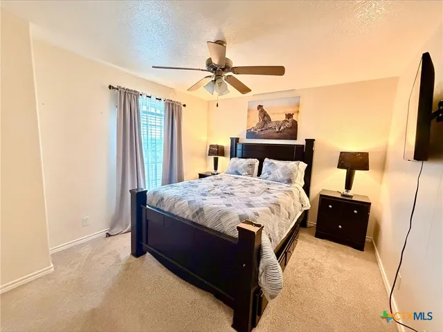 a bedroom with a bed and flat screen tv