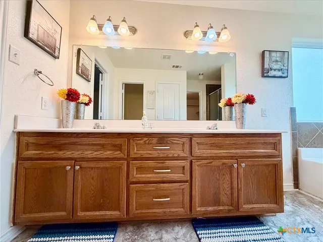 a bathroom with a sink a vanity and a mirror
