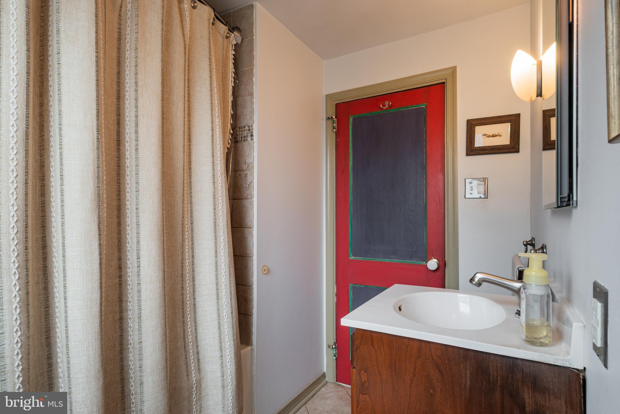 503 Burton Road Oreland, PA 19075 - Photo 29 of 29 a bathroom with a sink vanity and a mirror